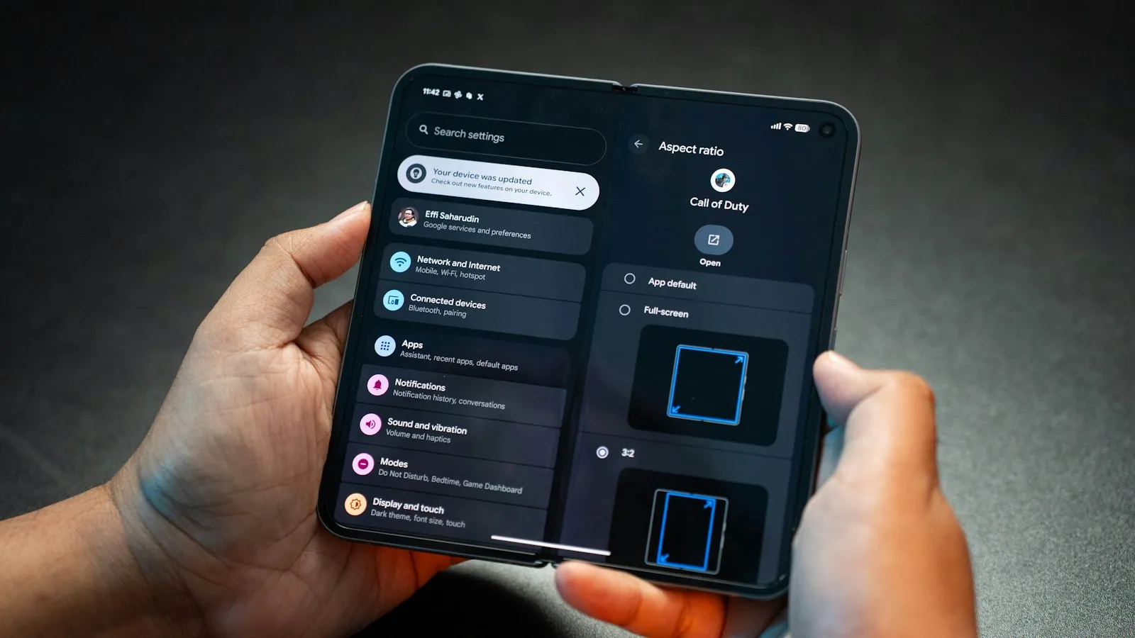 Hands holding an Android phone with the Settings app open on Network and Internet